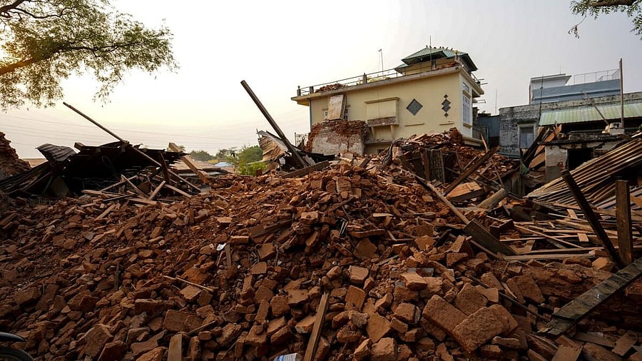<div class="paragraphs"><p>Rubble lies near a damaged building following a strong earthquake in Pyawbwe township, Mandalay, Myanmar.</p></div>
