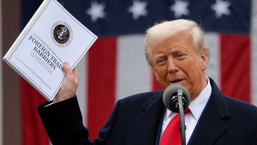 <div class="paragraphs"><p> US President Donald Trump holds a "Foreign Trade Barriers" document as he delivers remarks on tariffs in the Rose Garden at the White House in Washington.</p></div>