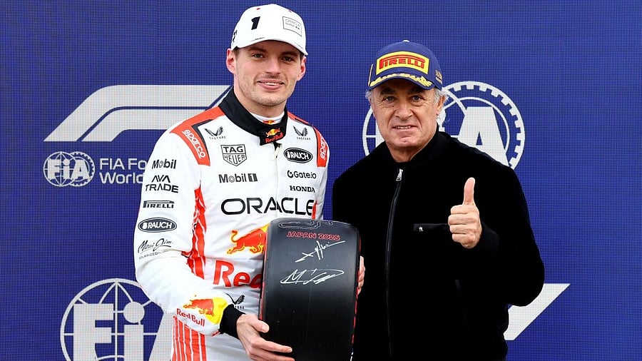 <div class="paragraphs"><p>Red Bull's Max Verstappen is presented with a trophy by Jean Alesi after qualifying in pole position.</p></div>
