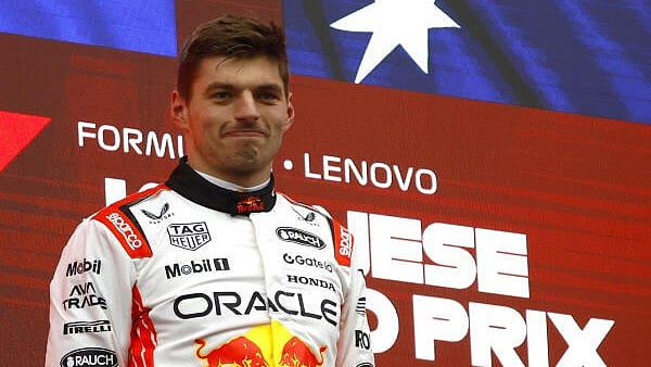 <div class="paragraphs"><p>Red Bull's Max Verstappen celebrates on the podium after winning the Japanese Grand Prix.</p></div>