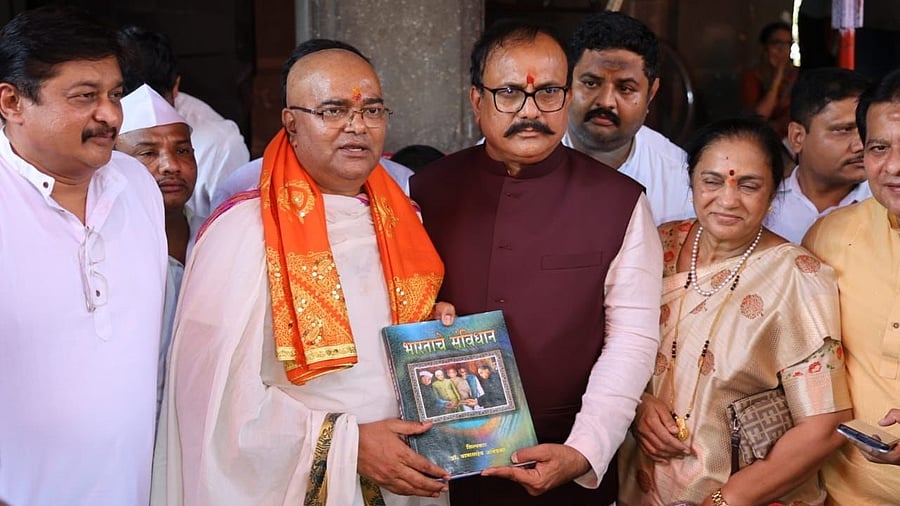 <div class="paragraphs"><p>Maharashtra Congress chief Harshavardhan Sapkal with a copy of the Indian Constitution at the Kalaram temple, April 6, 2025.</p></div>