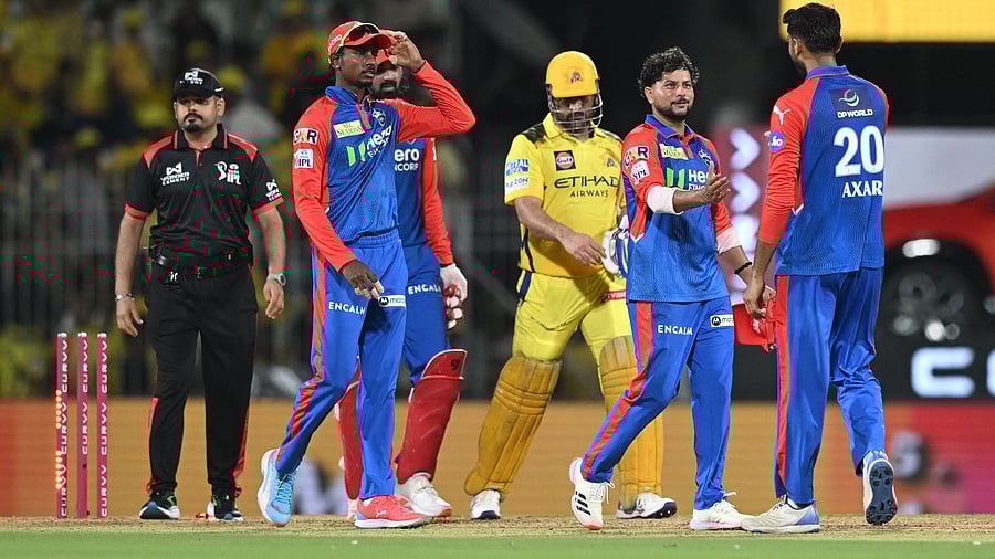 <div class="paragraphs"><p>Delhi Capitals' Kuldeep Yadav celebrates with Axar Patel as CSK's MS Dhoni looks dejected after the match.</p></div>