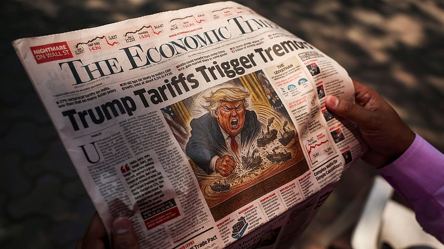 <div class="paragraphs"><p>A man reads a newspaper outside the Bombay Stock Exchange after Trump's tariff plan announcement.</p></div>