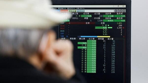 <div class="paragraphs"><p>A man looks at a computer screen displaying average stock prices at the Bank of Taiwan Securities in Taipei, Taiwan</p></div>