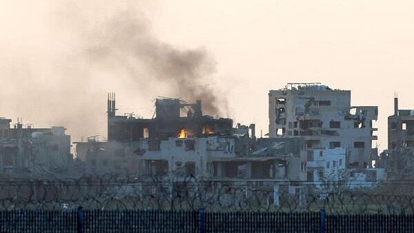 <div class="paragraphs"><p>Smoke rises from buildings in Gaza after an air strike, as seen from the Israeli side of the Israel-Gaza border.</p></div>