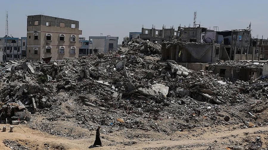 <div class="paragraphs"><p>A Palestinian walks near rubble of houses in Khan Younis, in the southern Gaza Strip, March 27, 2025.</p><p></p></div>