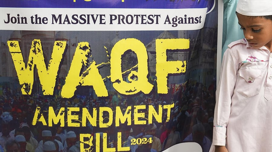 <div class="paragraphs"><p>A child stands beside a poster of a protest demanding roll back of waqf Amendment Act. (Representative image)</p></div>