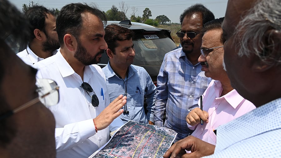 An official briefs the team from the Airports Authority of India during an inspection of the sites proposed for Bengaluru's second airport, at Karenahalli on Kanakapura main road in Bengaluru on Tuesday.