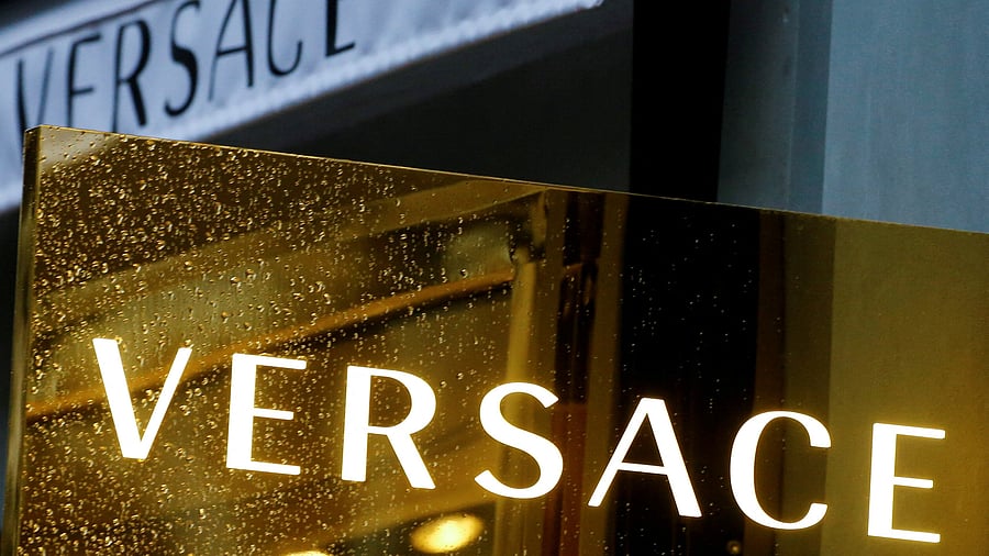<div class="paragraphs"><p> A sign with the logo of the Italian fashion house Versace is pictured </p></div>