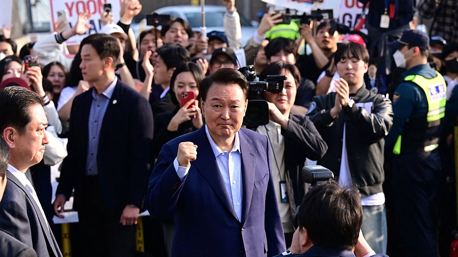 <div class="paragraphs"><p>Ousted former South Korean President Yoon Suk Yeol greets his supporters as he moves out of the presidential residence in Seoul.</p></div>