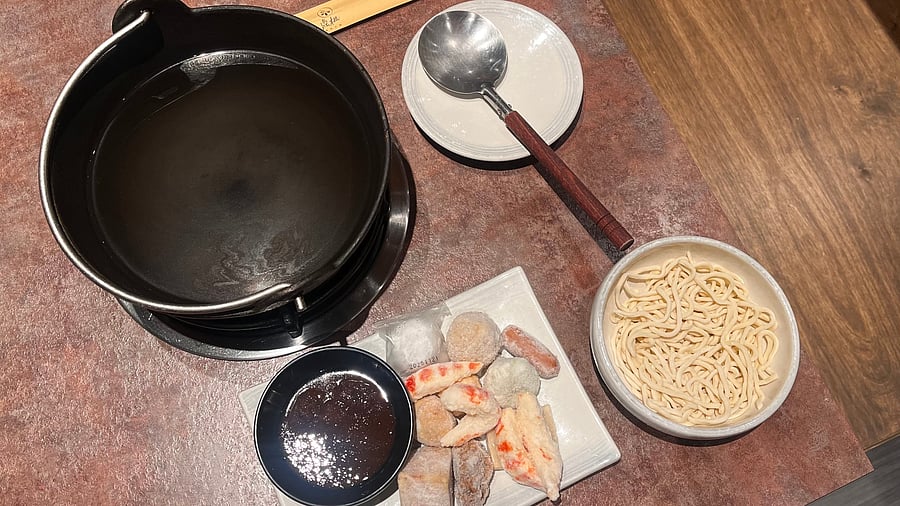 <div class="paragraphs"><p>A hot pot set-up with the burner, pan, frozen vegetables and soya. </p></div>