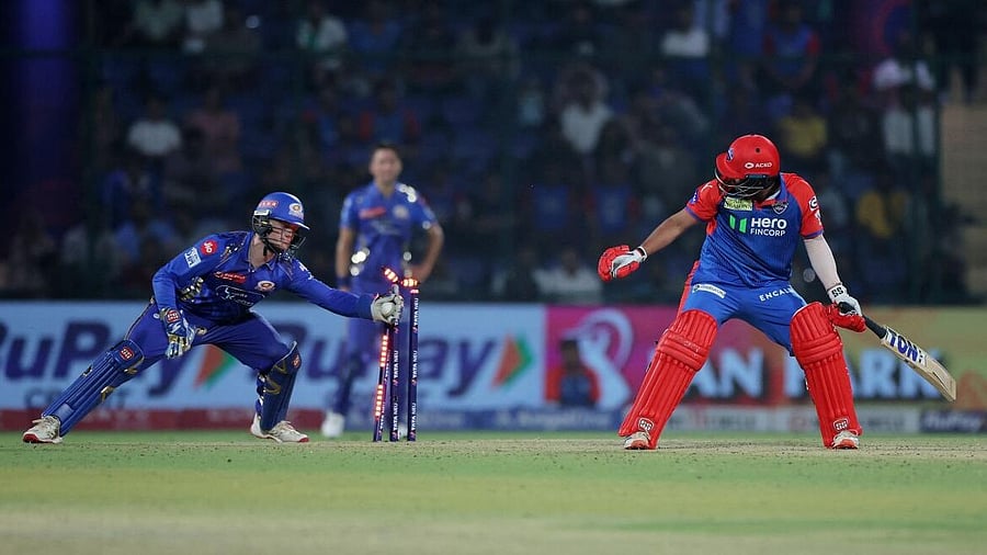 <div class="paragraphs"><p> Delhi Capitals' Vipraj Nigam is stumped out by Mumbai Indians' Ryan Rickelton.</p></div>