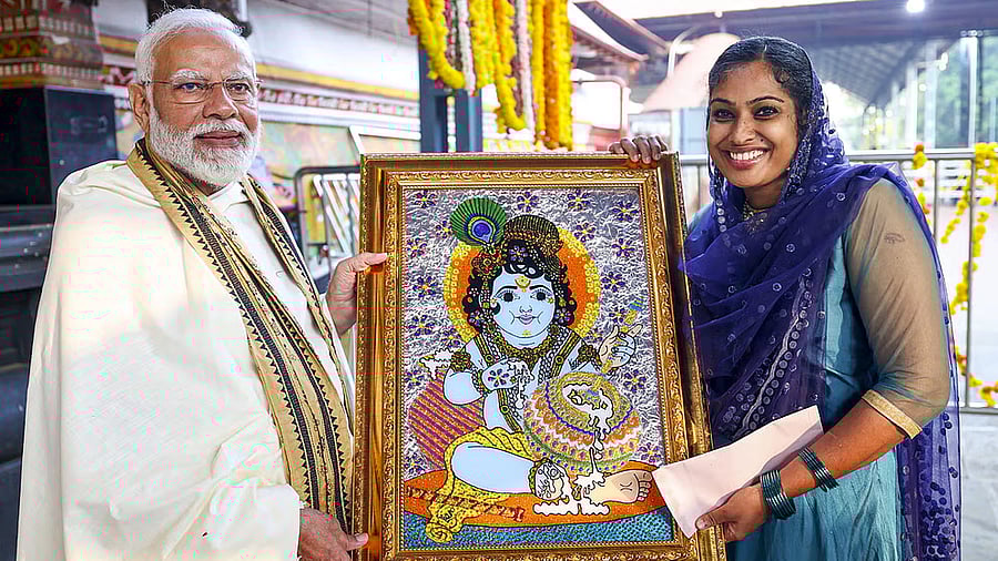 <div class="paragraphs"><p>Prime Minister Narendra Modi receives a lord Krishna painting from Jasna Salim.</p></div>