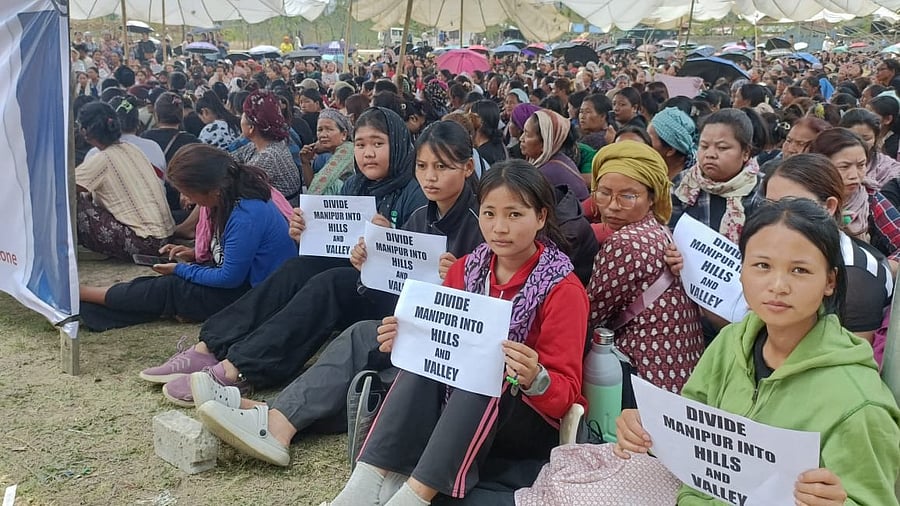 <div class="paragraphs"><p>Members of the Kuki community sit in protest.</p></div>