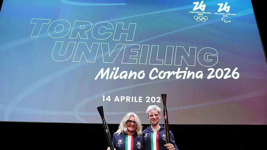 <div class="paragraphs"><p>Former Italian cross-country skier Stefania Belmondo and Paralympian Beatrice Vio hold the 2026 Milano Cortina Winter Olympics and Paralympic torches during a ceremony, April 14, 2025.</p></div>