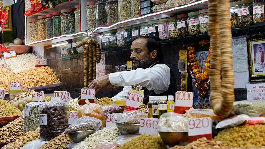 <div class="paragraphs"><p>A dry fruits seller sets up his shop as he waits for customers at a wholesale market in New Delhi, February 1, 2025. </p></div>