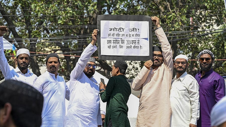<div class="paragraphs"><p>Muslims display a placard as they stage a protest against the Waqf Amendment Bill.</p></div>