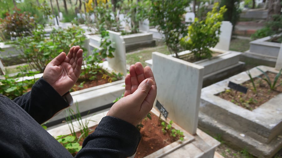 <div class="paragraphs"><p>A person praying at a burial ground.</p></div>