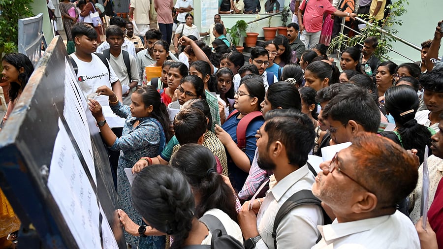 <div class="paragraphs"><p>Students check their registration numbers to appear for the Karnataka Common Entrance Test (KCET) at National College, Basavanagudi, in Bengaluru, on Wednesday. </p></div>
