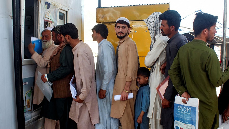 <div class="paragraphs"><p>Afghan nationals, who were expelled from Pakistan, stand in queue for registration upon their arrival at the Omari refugee camp in Mohmand Dara, Torkham border, Nangarhar province, Afghanistan, April 15, 2025. </p></div>