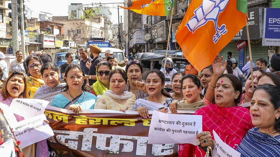 <div class="paragraphs"><p>BJP party workers raise slogans during a protest against the Congress party, in Jammu</p></div>