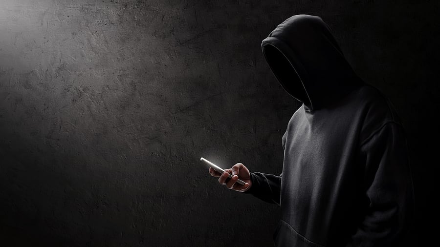 <div class="paragraphs"><p>A person in a hoodie looks at a phone.</p></div>