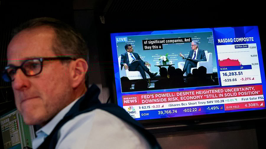 <div class="paragraphs"><p>A trader works as a screen broadcasts a live interview with US Federal Reserve Chair Jerome Powell, on the floor at the New York Stock Exchange  in New York.&nbsp;</p></div>