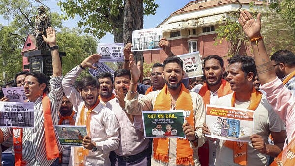 <div class="paragraphs"><p>Bharatiya Janata Party supporters stage a protest against Congress leaders Sonia Gandhi and Rahul Gandhi after the ED filed a chargesheet in the National Herald case, in Ahmedabad.</p></div>