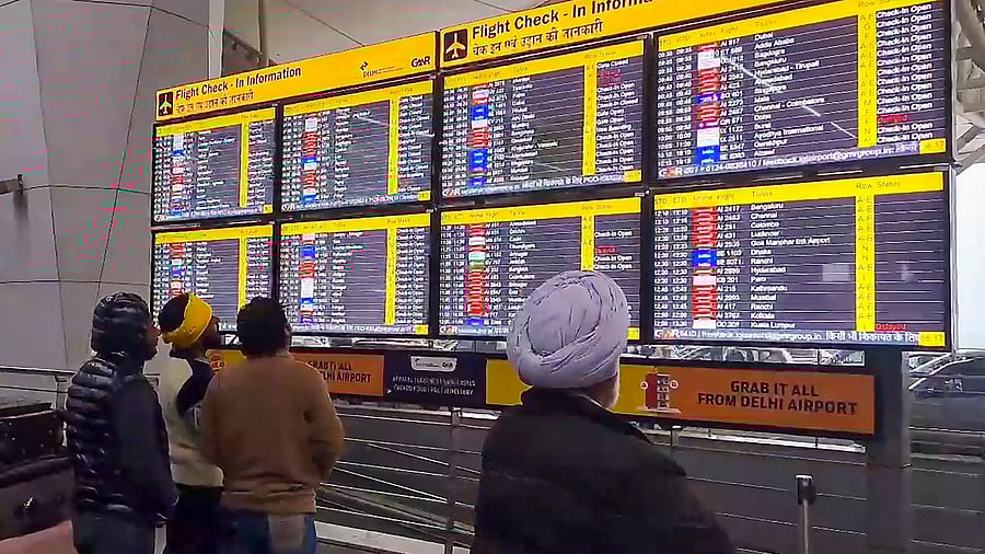 <div class="paragraphs"><p>Passengers look at the display board for information at the Delhi Airport </p></div>