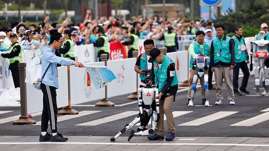 <div class="paragraphs"><p>An engineer holds a humanoid robot after it fell at the starting line during the E-Town Half Marathon &amp; Humanoid Robot Half Marathon in Beijing, China April, 19 2025. </p></div>