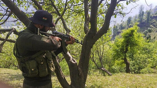 <div class="paragraphs"><p>A security personnel keeps vigil after a brief exchange of fire took place between terrorists and security forces in Lasana village of Surankote, in Jammu and Kashmir’s Poonch district</p></div>