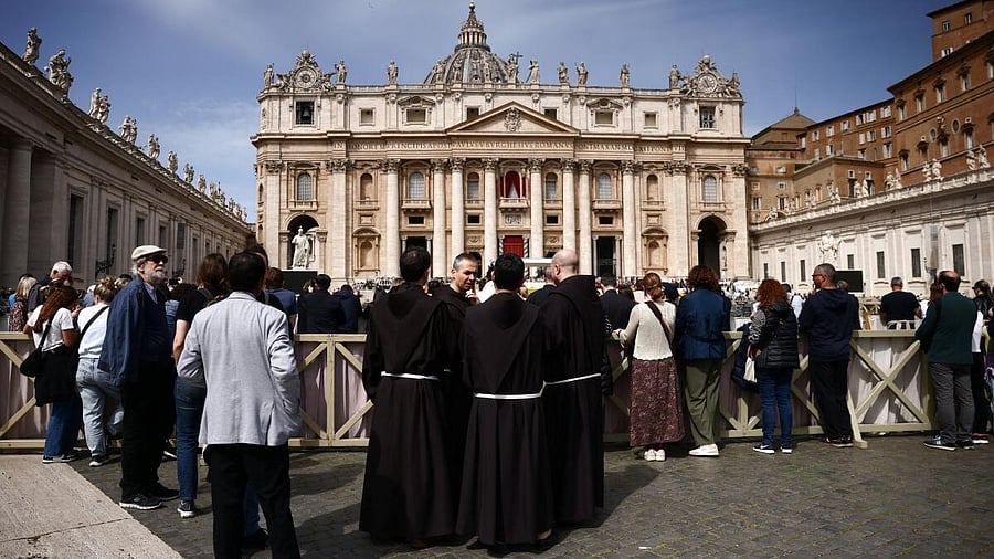 <div class="paragraphs"><p>Clergy members stand in St. Peter's Square, after the death of Pope Francis was announced by the Vatican in a video statement, at the Vatican, April 21, 2025.</p></div>