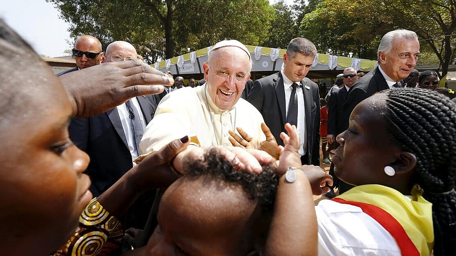 <div class="paragraphs"><p>File photo of Pope Francis blessing a child as he visits the refugee camp. </p></div>