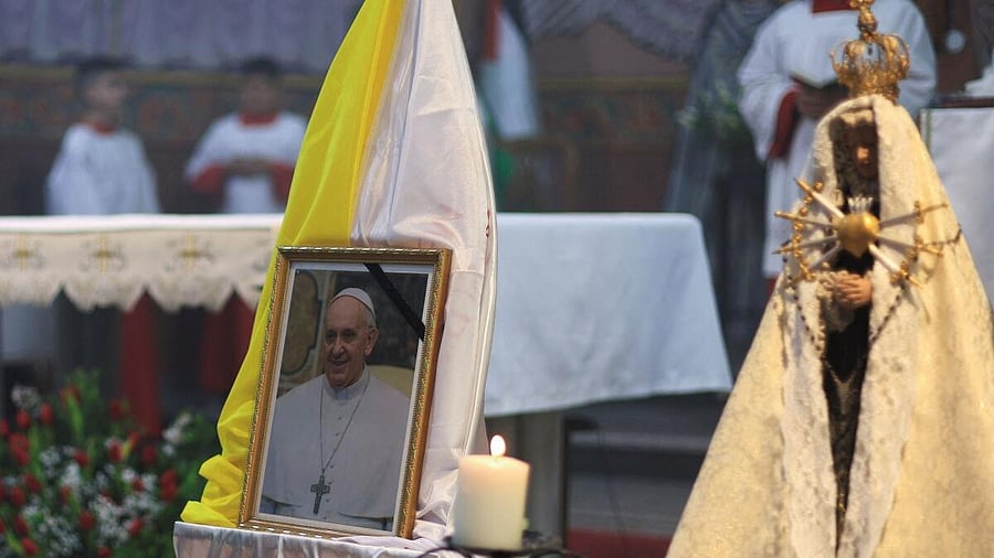 <div class="paragraphs"><p>A portrait of Pope Francis is displayed during a Mass at the Holy Family Church</p></div>
