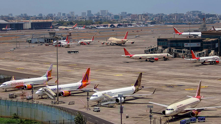 <div class="paragraphs"><p>Air India and other planes parked at an airport.</p></div>