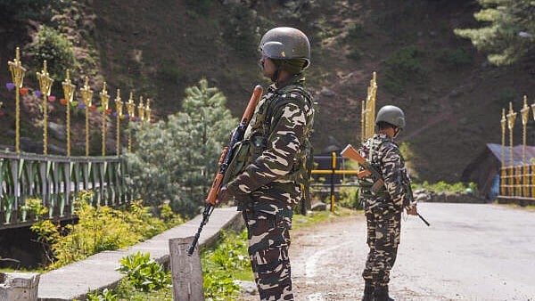 <div class="paragraphs"><p>Security personnel stand guard a day after a terrorist attack in Pahalgam, J & K, Wednesday morning.</p></div>