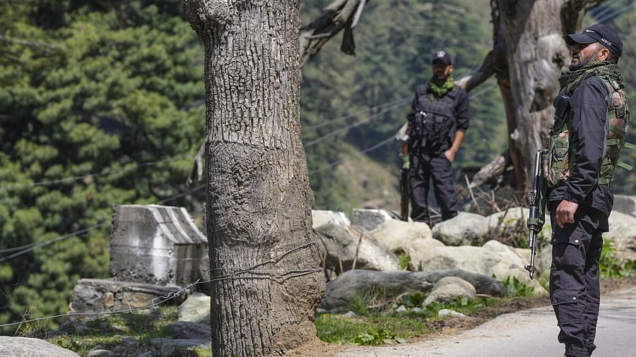 <div class="paragraphs"><p>Security personnel stand guard a day after a terrorist attack in Pahalgam, J &amp; K, Wednesday morning.</p></div>