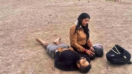 <div class="paragraphs"><p>A woman sits next to a man lying on the ground after terrorists attacked a group of tourists at Pahalgam, in Anantnag district, Jammu &amp; Kashmir</p></div>