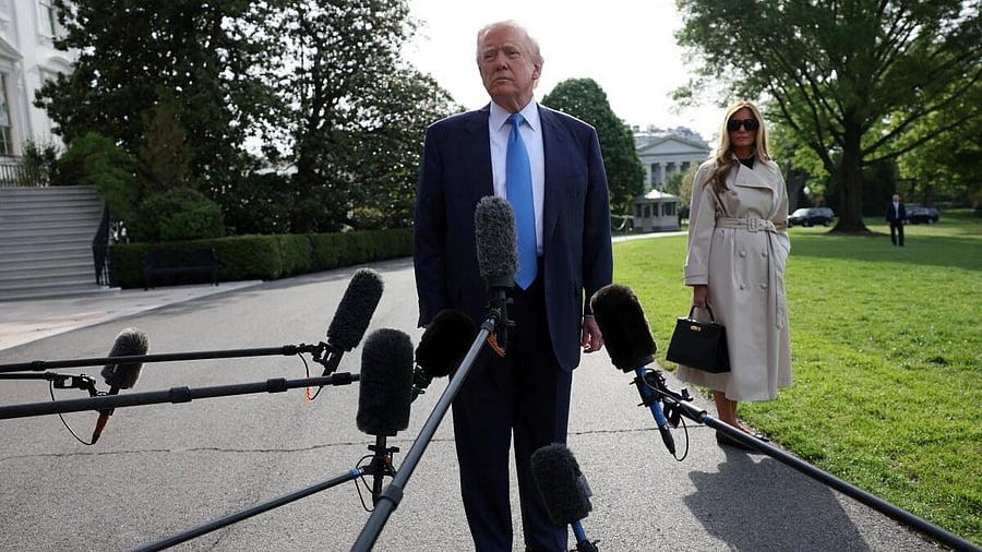 <div class="paragraphs"><p>US President Donald Trump speaks to members of the media next to first lady Melania Trump as they depart for Rome, Italy, to attend Pope Francis' funeral, at the White House in Washington, D.C., US, April 25, 2025.</p></div>