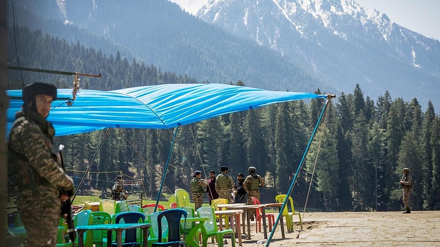 <div class="paragraphs"><p>Indian security force personnel talks to the local people at the site of a suspected militant attack on tourists in Baisaran near Pahalgam.</p></div>