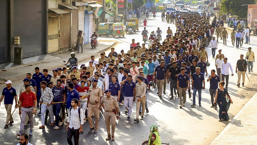 <div class="paragraphs"><p>Police take away more than 450 immigrants, allegedly residing illegally, after they detained in a combing operation in different localities, in Ahmedabada, Saturday, April 26.</p></div>