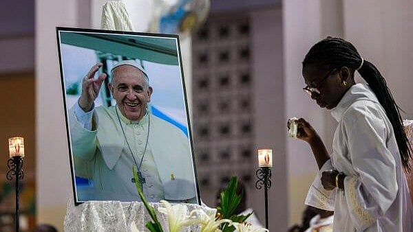 <div class="paragraphs"><p>An altar girl replaces a candle as she attends a Mass in honor of Pope Francis at Notre-Dame des Victoires Cathedral in Dakar.</p></div>