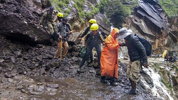 <div class="paragraphs"><p> State Disaster Response Force (SDRF) team helps pilgrims cross damaged path on the route of Kailash Mansarovar Yatra, in Pithoragarh district, Sunday, Aug 18, 2019.</p></div>