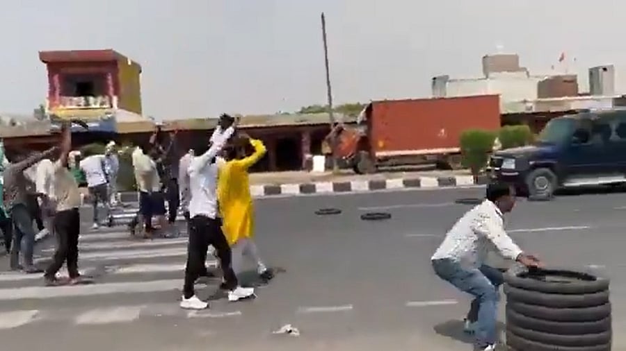 <div class="paragraphs"><p>Screengrab from video showing Karni Sena members preparing to throw tires at SP MP Ramjilal Suman's convoy.</p></div>