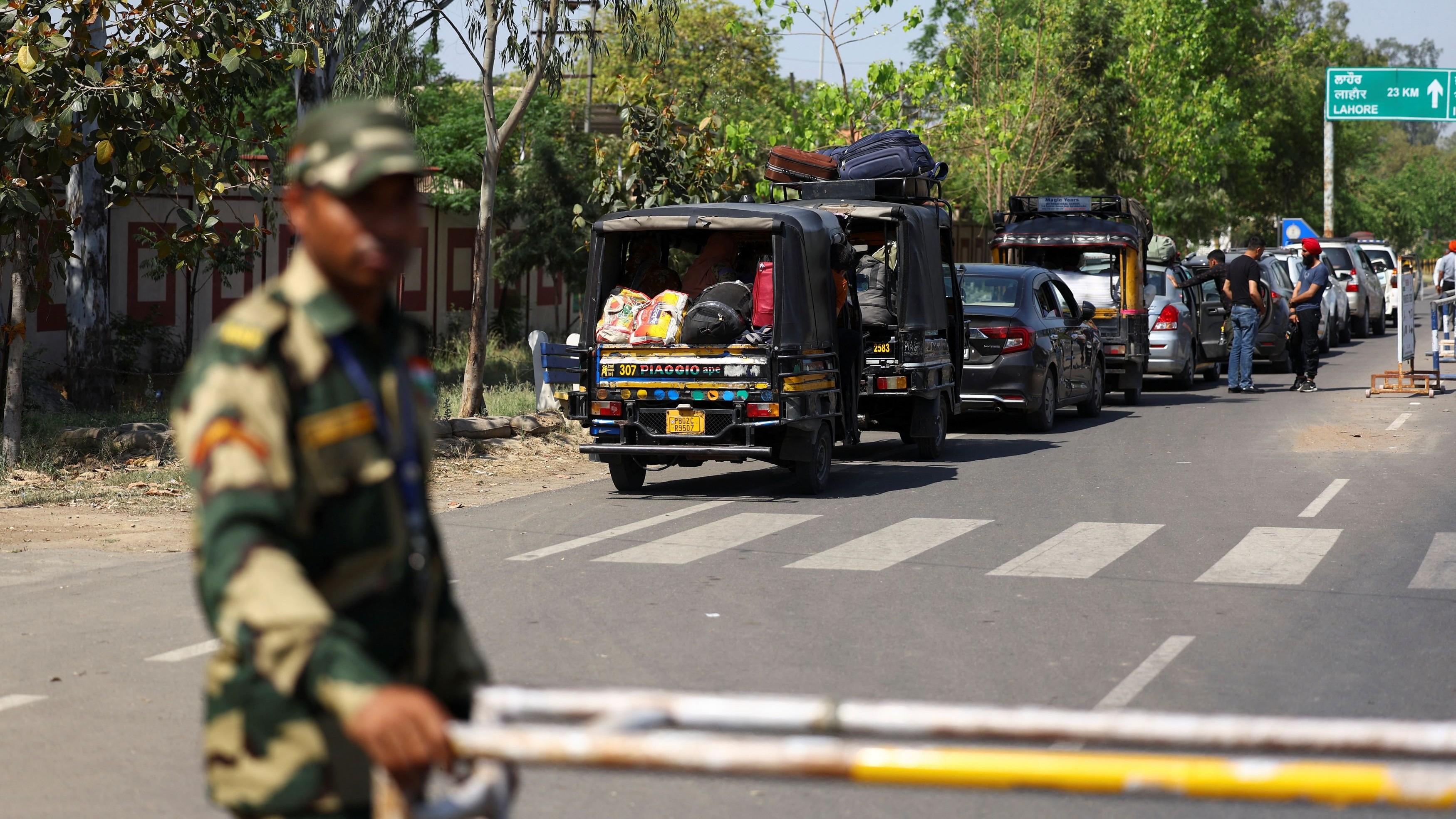 <div class="paragraphs"><p>A military personnel with the Border Security Force stands guard, as vehicles having Pakistani citizens line up near the Integrated check post, as they prepare to leave India after India revoked visas issued to Pakistani citizens, at the Attari-Wagah border crossing near Amritsar, India, April 27, 2025. India has suspended visa services to Pakistani nationals "with immediate effect" following an attack on tourists near Pahalgam in south Kashmir. </p></div>