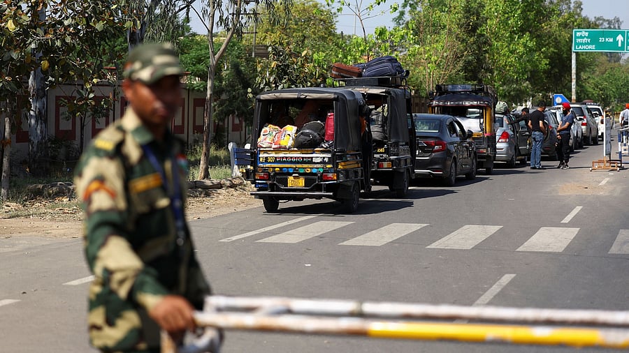 <div class="paragraphs"><p>A military personnel with the Border Security Force stands guard, as vehicles having Pakistani citizens line up near the Integrated check post, as they prepare to leave India after India revoked visas issued to Pakistani citizens, at the Attari-Wagah border crossing near Amritsar, India, April 27, 2025. </p></div>