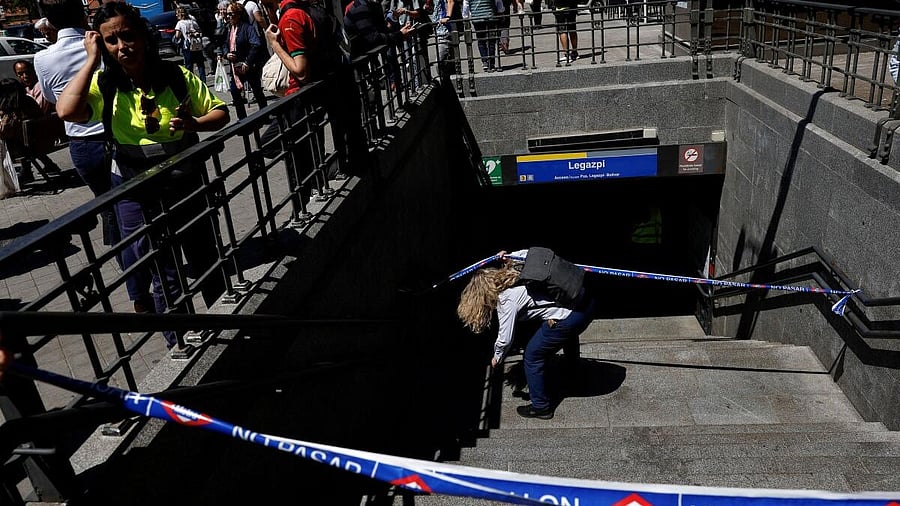 <div class="paragraphs"><p>A metro worker passes underneath barricade tape, to enter Legazpi Metro station, after the metro was closed during a power outage in Madrid.</p></div>
