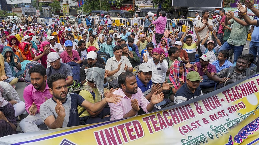 <div class="paragraphs"><p>Teachers who lost their job following a court verdict, sit on the road in Kolkata as a sign of protest.</p></div>