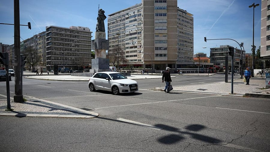 <div class="paragraphs"><p>A person walks on a crosswalk as a car passes by during a power outage in Lisbon, Portugal April 28, 2025.</p></div>