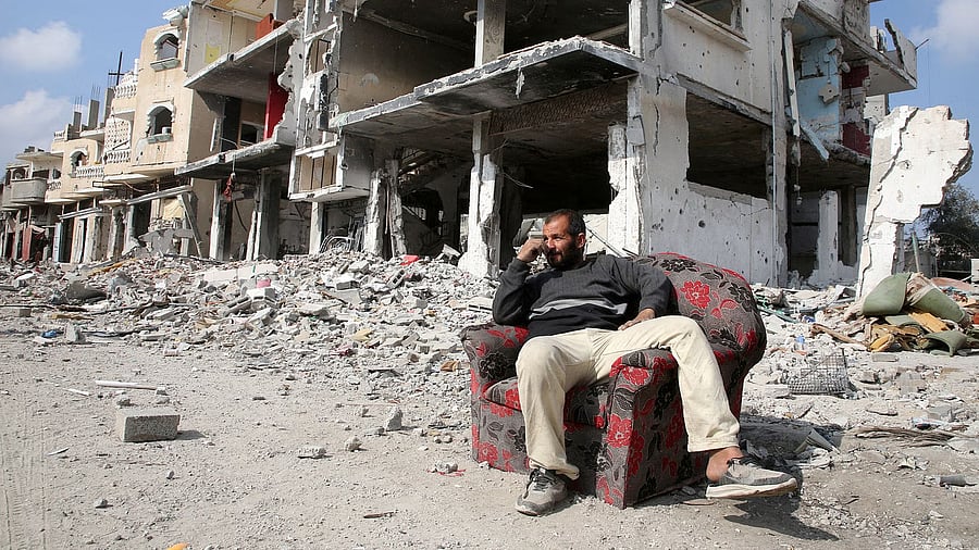 <div class="paragraphs"><p>A Palestinian sits among the rubble of buildings destroyed during the Israeli offensive, amid a ceasefire between Israel and Hamas, in Rafah in the southern Gaza Strip February 4, 2025. Credit: Reuters Photo</p></div>